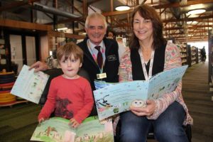 Young Hills students distribute storm weather event book to the community